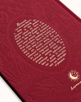 Red embossed book with text and design on a white background
