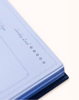 Folded light blue fabric with text on a white background