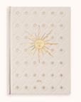 Cream-colored Gratitude Journal with gold sun design and 'SOL' text on a white background