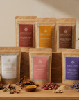 Collection of Herbal Cacao packaging on a wooden surface with natural elements.