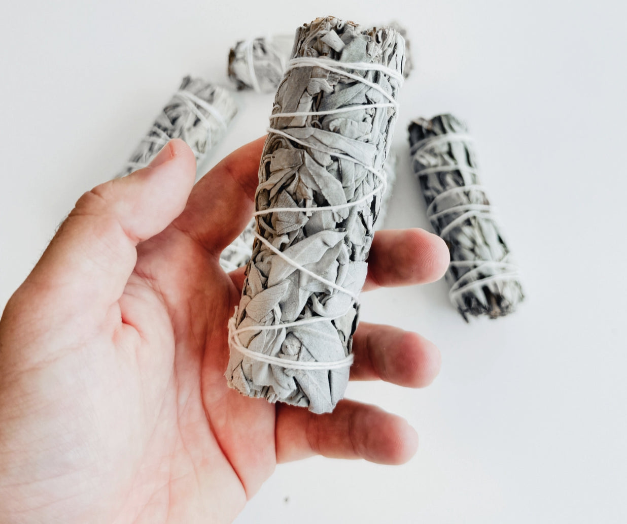Holding a Herbal Smudge Stick