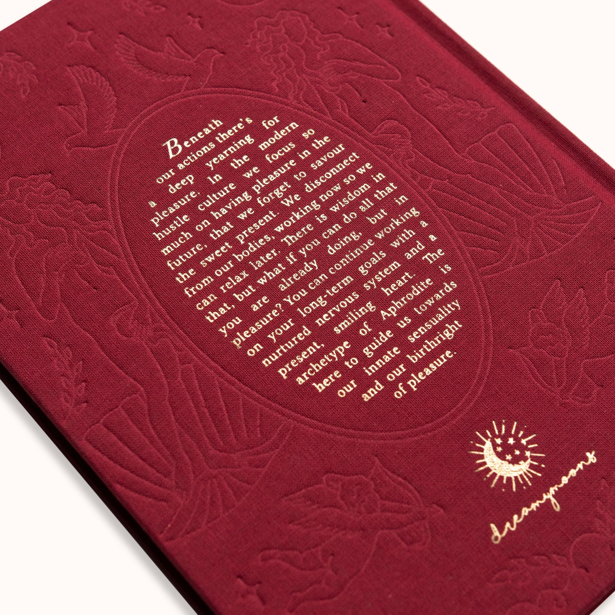 Red embossed book with text and design on a white background