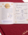 Open journal with philosophical text and illustrations on a red embossed surface