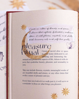 Open journal with decorative text and illustrations on a textured surface