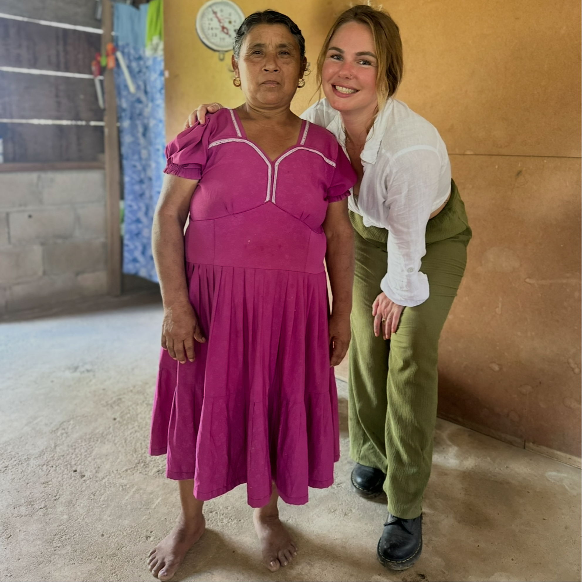 Cacao_Farmer_Maya_Mountain women with sharon standing together in a room with a clock on the wall.