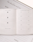 Open Gratitude Journal with lined pages on a matching cover, featuring text and design elements.