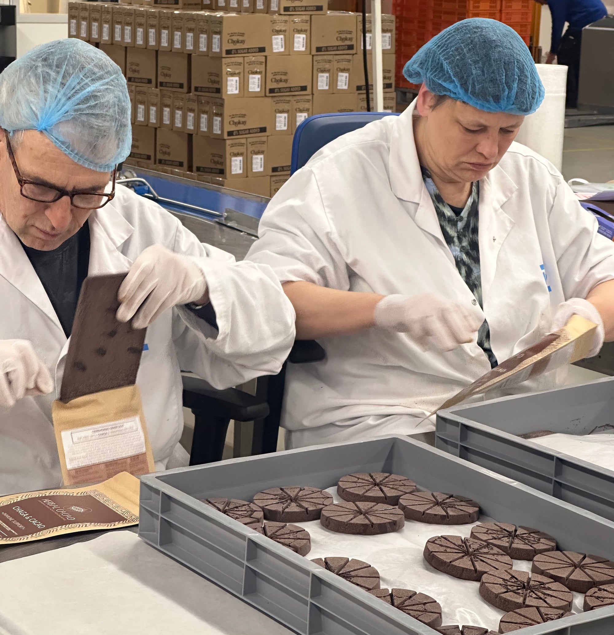 Two DZB workers packaging Herbal Cacao