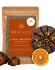 A pouch of Herbal Cacao Divine Strength Chaga & Cacao, orange blends, shown with two dark brown chaga root pieces and a dried orange slice on a clean white background.