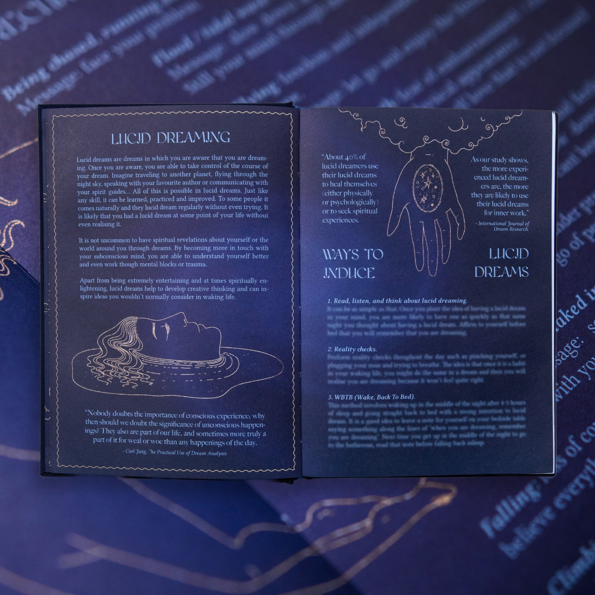 Open dream journal book with text and illustrations on a blue background