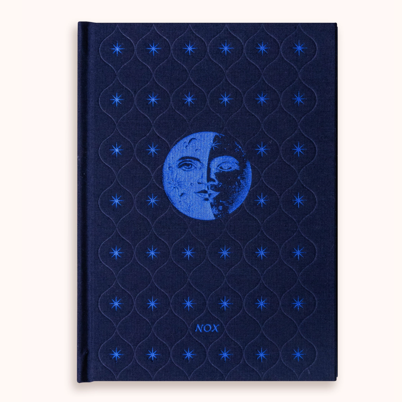 Blue dream journal with moon and star design on a white background