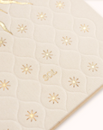 Beige quilted surface with gold star patterns and 'SOL' branding.