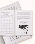 Open Gratitude Journal with habit tracker and black and white illustrations on a white background