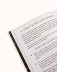 Book Gratitude Journal to a page with text on practicing gratitude on a white background