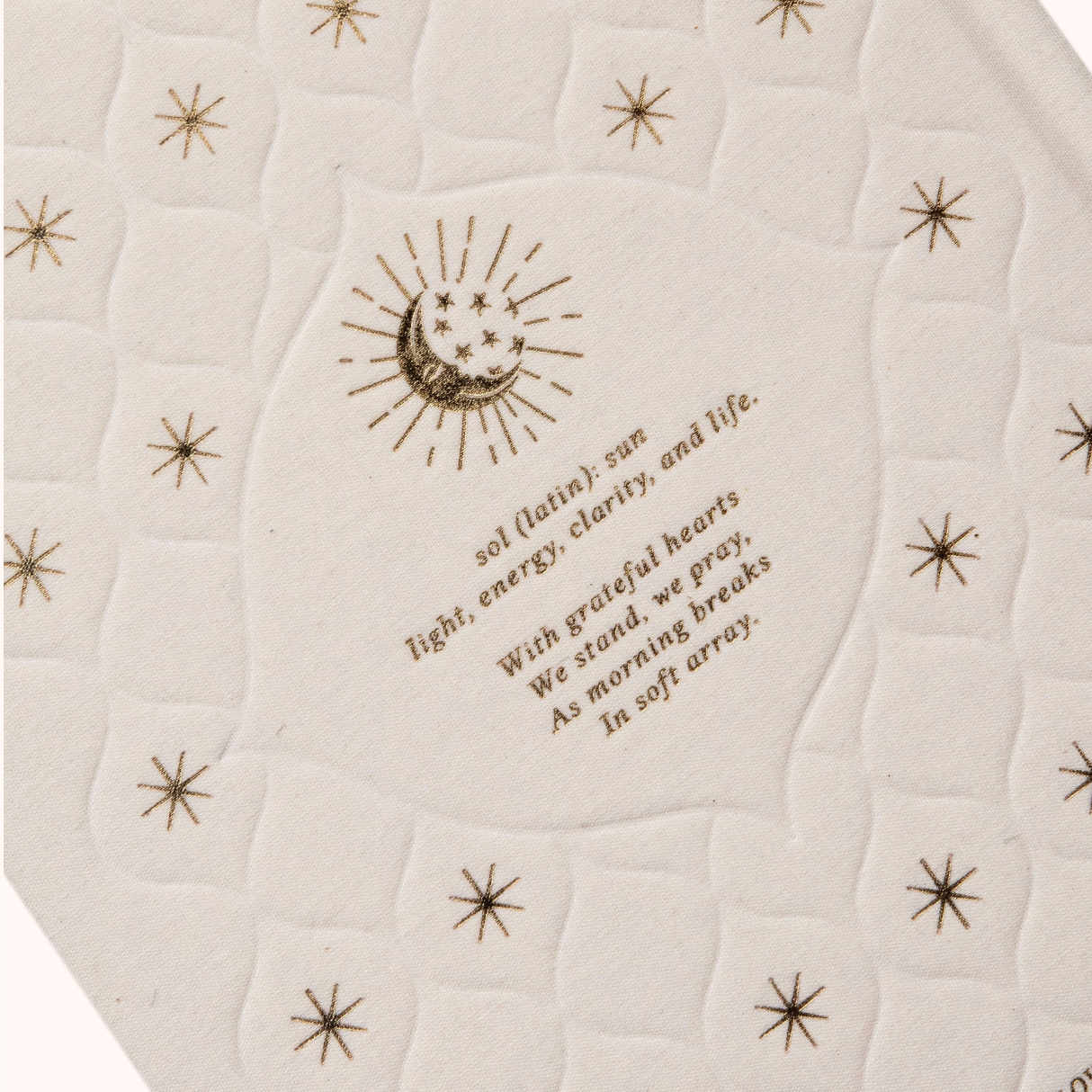 Quilt with embroidered design and text on a white background