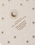 Quilt with embroidered design and text on a white background