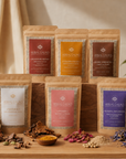 Collection of Herbal Cacao packaging on a wooden surface with natural elements.