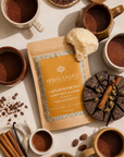 Herbal Cacao lionsmane cacao blend including cacao mugs and ingredients on a beige surface.