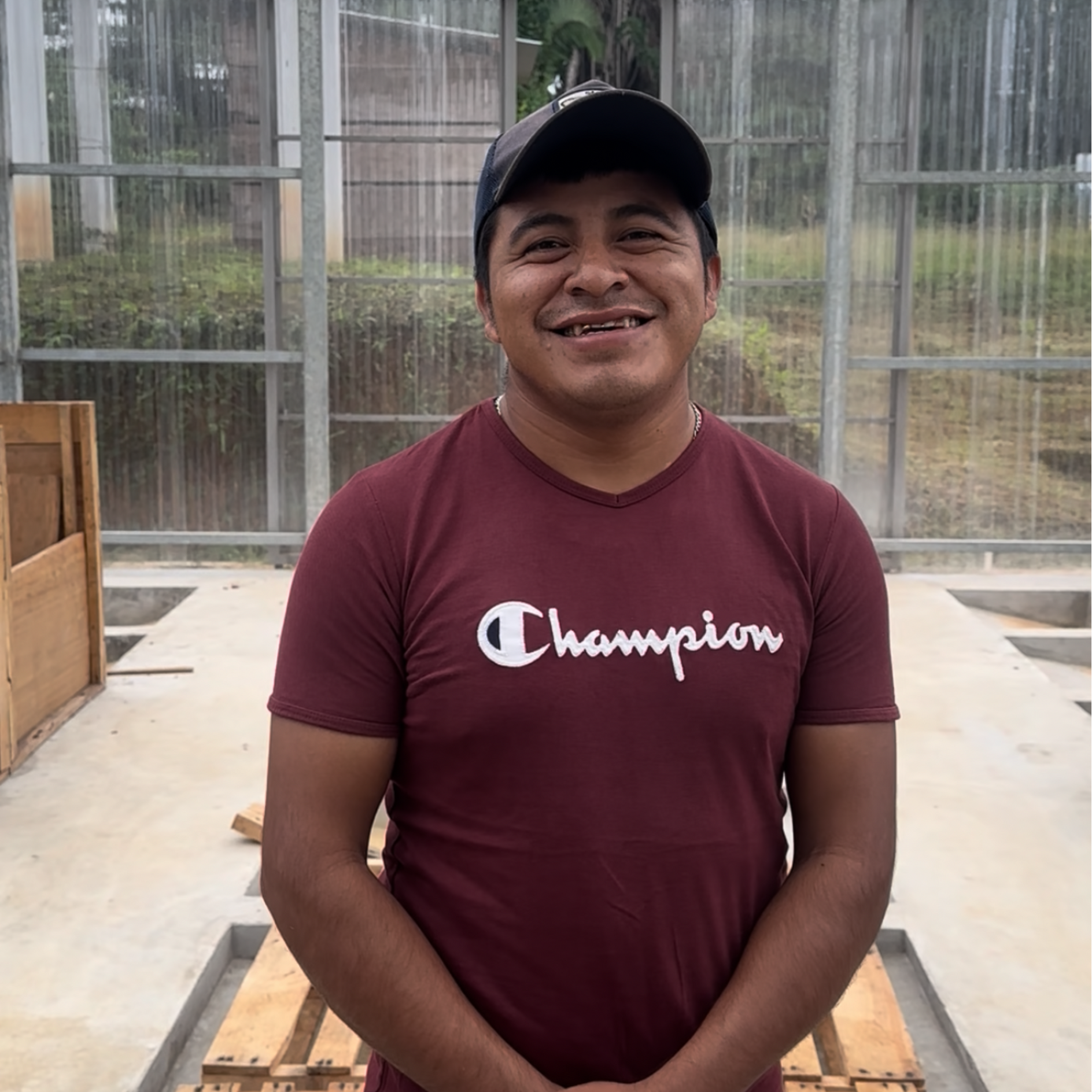 Maya_Cacao_Farmer_Guatemala wearing a t-shirt standing in a cacao fermentation centre 