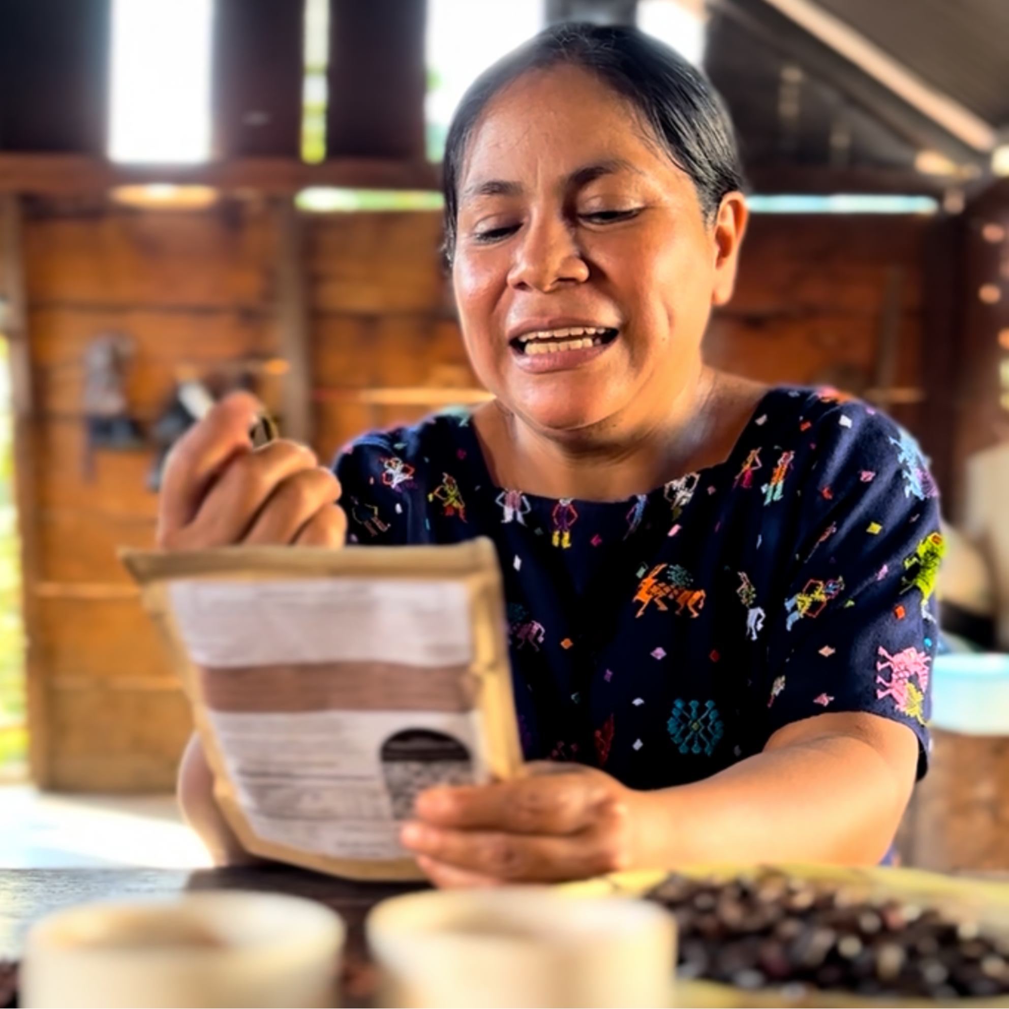 Woman holding a herbal cacao package with cacao beans on a table
