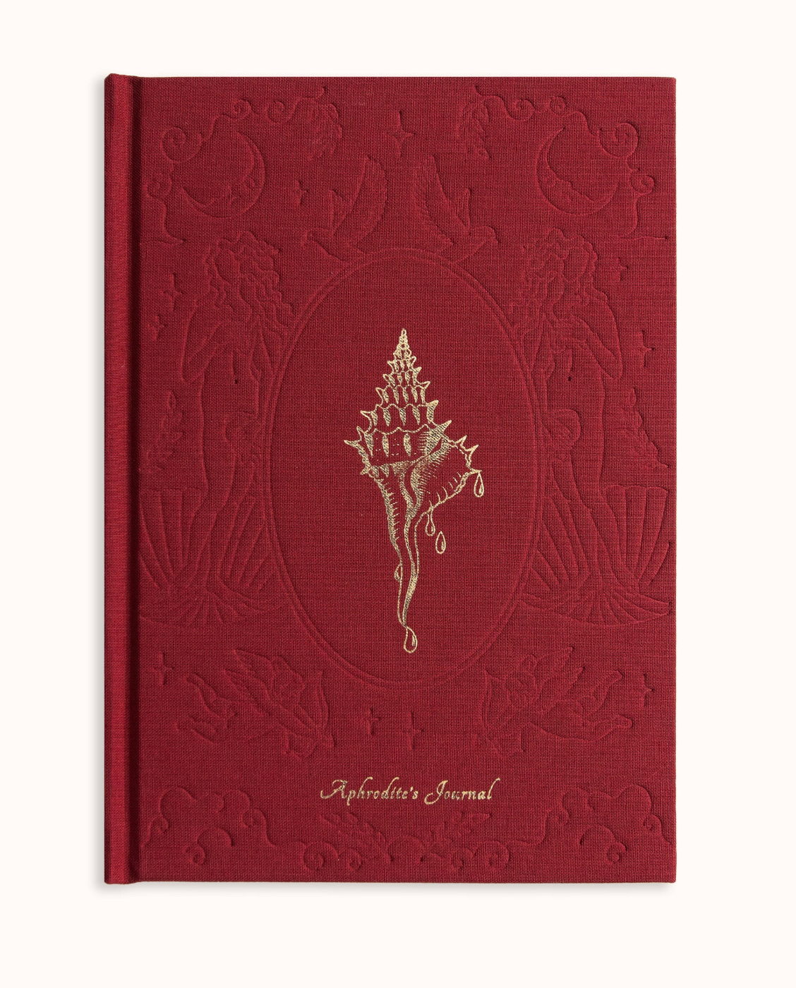 Red journal with embossed shell design and 'Aphrodite's Journal' text on a white background