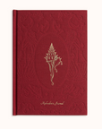 Red journal with embossed shell design and 'Aphrodite's Journal' text on a white background