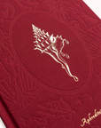Red embossed book with a shell design and 'Aphrodite's Journal' text on a white background