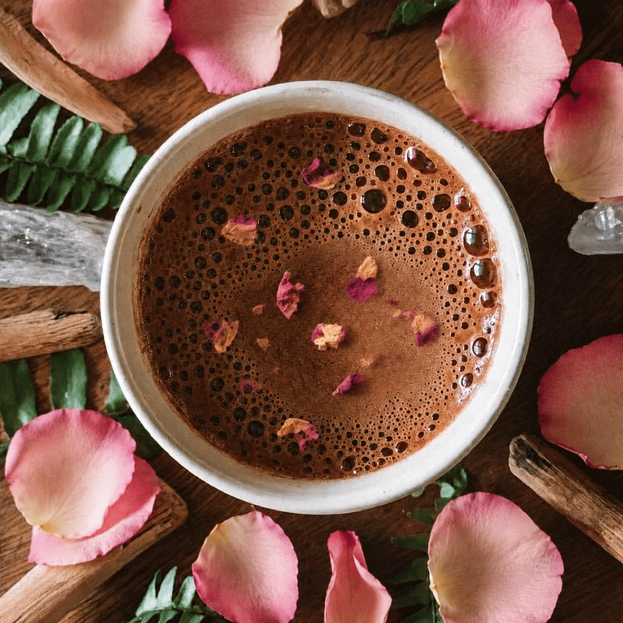 Rose Petals in and around a cup of Ceremonial Cacao Pasion from Herbal Cacao