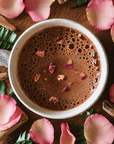 Rose Petals in and around a cup of Ceremonial Cacao Pasion from Herbal Cacao
