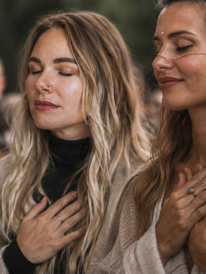 two women, including Sharon Fernie founder Herbal Cacao, touching their hearts with a smile on their faces.