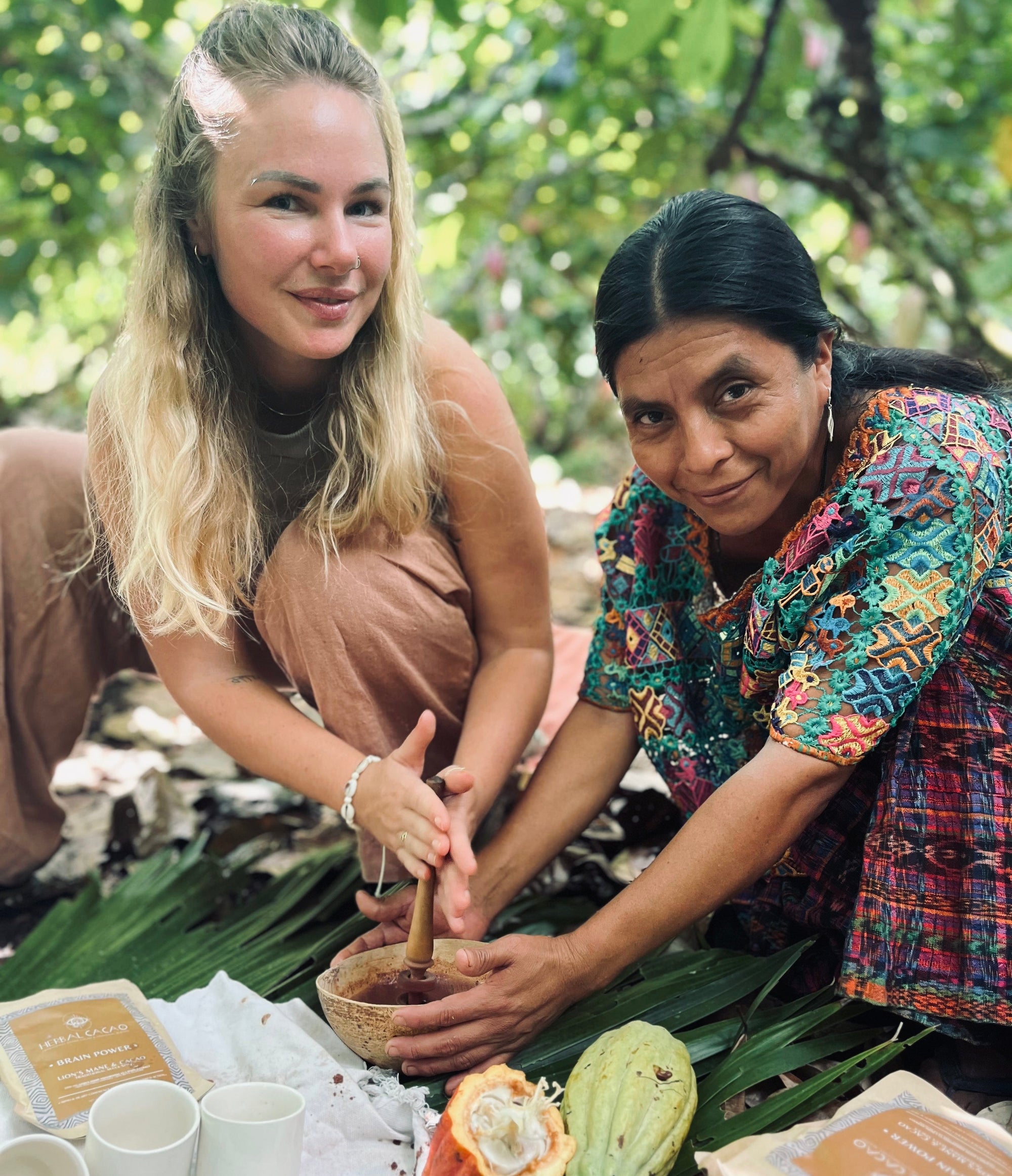 Two women preparing a cup of ceremonial caccao in the cacao jungle