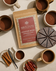 Herbal Cacao product with mugs of cacao, vanilla beans, and cinnamon on a beige background