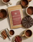 Herbal Cacao product with mugs of cacao, vanilla beans, and cinnamon on a beige background