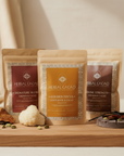 Three bags of Herbal Cacao on a wooden surface with decorative elements.