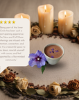 Cup of cacao with flowers and candles as a altar
