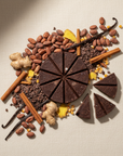 ceremonial cacao pieces with spices and nuts arranged on a textured surface